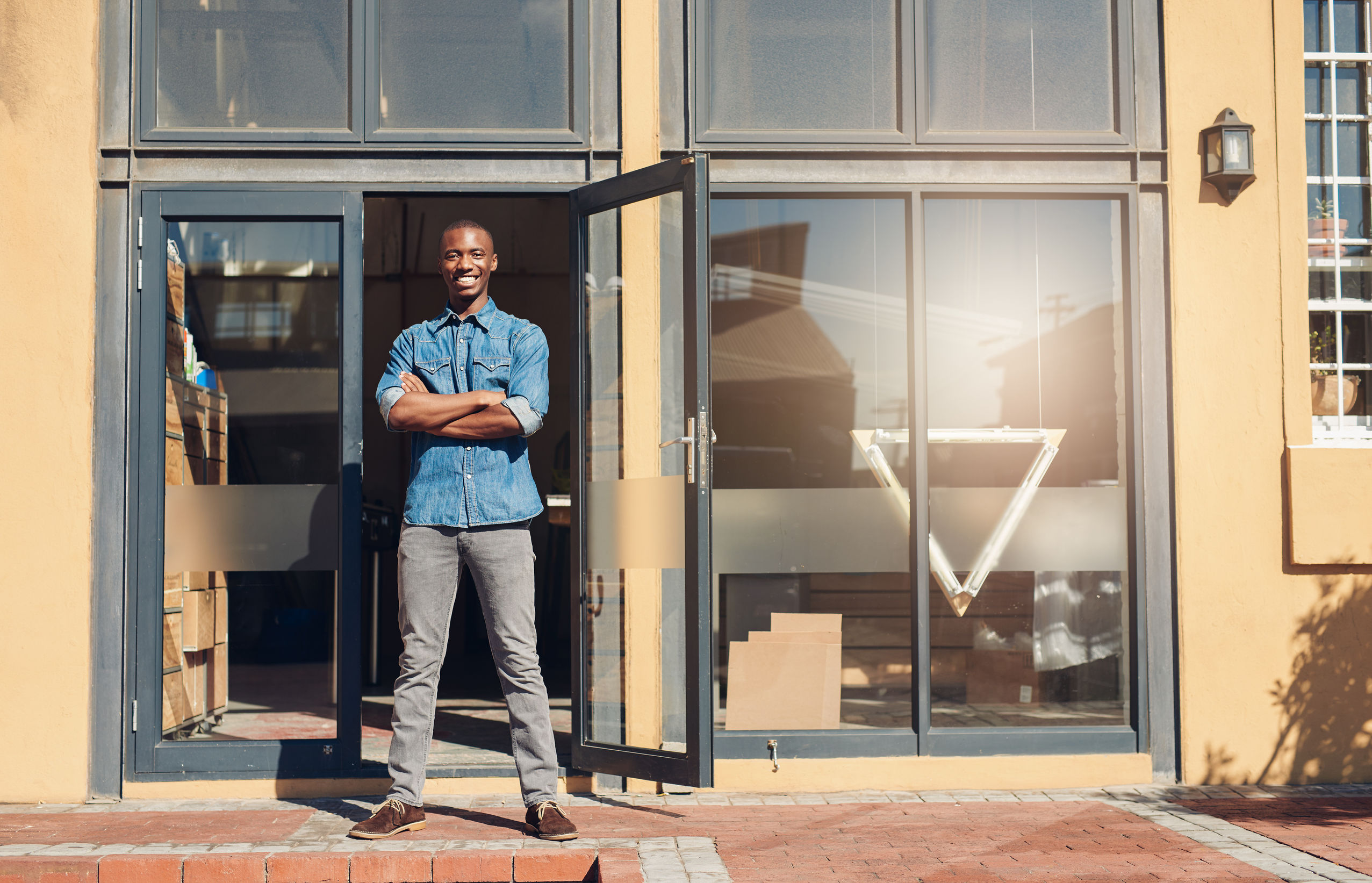 a man stands in the doorway of his office | home and office security systems colorado